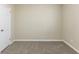 Cozy bedroom with neutral carpet, white walls, and a door on the left side at 6297 Temple St, Lithia Springs, GA 30122