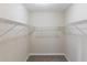 Walk-in closet with ample storage and neutral carpeting at 6297 Temple St, Lithia Springs, GA 30122