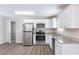 Well-lit kitchen with white cabinets and modern stainless steel appliances at 6297 Temple St, Lithia Springs, GA 30122