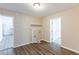 Bright laundry room with wood flooring, utility connections, and an open doorway at 6297 Temple St, Lithia Springs, GA 30122