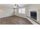 Light and airy living room with fireplace, ceiling fan, and laminate flooring at 6297 Temple St, Lithia Springs, GA 30122