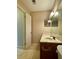 Neutral bathroom with a marble countertop, traditional fixtures, and a mirrored wall cabinet at 6900 Roswell Rd # 7N, Atlanta, GA 30328