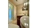 Bathroom featuring tiled floor, modern sink, and fixtures beneath bright lighting and mirrored cabinets at 6900 Roswell Rd # 7N, Atlanta, GA 30328