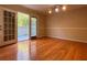 Bright living room features hardwood floors and sliding glass doors leading to patio at 6900 Roswell Rd # 7N, Atlanta, GA 30328