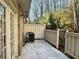 A small patio featuring a wooden fence, AC Unit and the side of a brick building at 6900 Roswell Rd # 7N, Atlanta, GA 30328