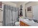 Bathroom with a shower/tub combo, stylish shower curtain, and a sink vanity at 8034 Bradshaw Ct, Douglasville, GA 30134