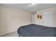 Minimalist bedroom with a gray bedspread, neutral carpet, and ample natural light at 8034 Bradshaw Ct, Douglasville, GA 30134