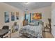 Bedroom featuring beach-themed decor, a cozy bed, and neutral-colored carpet at 8034 Bradshaw Ct, Douglasville, GA 30134