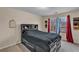 Cozy bedroom featuring a black platform bed, bright natural light, and colorful curtains framing the window at 8034 Bradshaw Ct, Douglasville, GA 30134