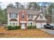 Charming two-story home featuring a brick and vinyl facade, double garage, and well-maintained landscaping at 8034 Bradshaw Ct, Douglasville, GA 30134