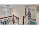 Bright hallway with staircase, modern chandelier and view to bathroom at 8034 Bradshaw Ct, Douglasville, GA 30134