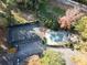 Aerial view of a tennis court, covered pool, parking and verdant landscaping and mature trees at 1482 N Crossing Ne Cir, Atlanta, GA 30329