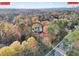 An aerial view of a home in a wooded area in Atlanta near Buckhead at 1482 N Crossing Ne Cir, Atlanta, GA 30329