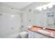 A tiled bathroom featuring a vanity with marble countertop and a shower-tub combo at 1482 N Crossing Ne Cir, Atlanta, GA 30329