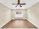 A bright, unfurnished bedroom with hardwood floors, ceiling fan and a large window at 1482 N Crossing Ne Cir, Atlanta, GA 30329