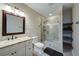 Modern bathroom featuring tile floors, glass shower with a bench, and marble vanity at 322 Kells Ct, Woodstock, GA 30188