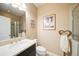 The bathroom features a vanity with a sink and a framed mirror at 322 Kells Ct, Woodstock, GA 30188