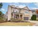 Inviting two-story home featuring a covered porch, stone accents, and well-kept landscaping in a desirable neighborhood at 322 Kells Ct, Woodstock, GA 30188