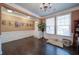 Bright foyer with hardwood floors, wainscoting, and abundant natural light streaming through windows, creating a welcoming entrance at 322 Kells Ct, Woodstock, GA 30188