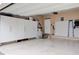 Spacious garage with epoxy flooring and ample storage cabinets, perfect for organization and parking at 322 Kells Ct, Woodstock, GA 30188