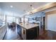 Open kitchen view with granite counters and dark wood floors extends into the dining and living area at 322 Kells Ct, Woodstock, GA 30188