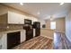 Kitchen featuring modern appliances, tile backsplash, white cabinets, and hardwood floors at 322 Kells Ct, Woodstock, GA 30188