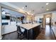 The kitchen island has barstool seating with modern lighting and an open floor plan at 322 Kells Ct, Woodstock, GA 30188