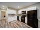 Modern kitchen featuring stainless steel appliances, white cabinets, and hardwood floors at 322 Kells Ct, Woodstock, GA 30188