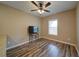 Bright living area featuring hardwood floors, a ceiling fan, and a window at 322 Kells Ct, Woodstock, GA 30188