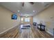 Spacious living room with wood floors, ceiling fan, and a door leading to the backyard at 322 Kells Ct, Woodstock, GA 30188