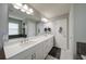 Main bathroom with dual sinks, bright vanity, and a large mirror offering plenty of room at 322 Kells Ct, Woodstock, GA 30188