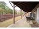 Relaxing outdoor patio with a view of the spacious backyard and fence at 322 Kells Ct, Woodstock, GA 30188