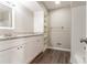 Bathroom featuring granite countertop, white cabinets, and built-in shelves at 4124 Casa Loma Dr, Decatur, GA 30034