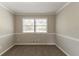 A bedroom with neutral paint, plush carpet, and a window providing ample natural light at 4124 Casa Loma Dr, Decatur, GA 30034