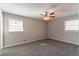 This bedroom features two windows, ceiling fan, and carpet flooring at 4124 Casa Loma Dr, Decatur, GA 30034