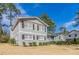 Gray home with black shutters and lush landscaping in a peaceful, tree-lined setting at 4124 Casa Loma Dr, Decatur, GA 30034