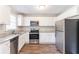 Modern kitchen with stainless steel appliances, granite countertops, and white cabinets at 4124 Casa Loma Dr, Decatur, GA 30034