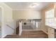 Open living area featuring wood floors, white railing, and stone fireplace in the background at 4124 Casa Loma Dr, Decatur, GA 30034