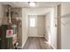 Utility room with a white door, grey water heater, and wire shelving at 4124 Casa Loma Dr, Decatur, GA 30034