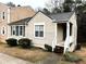 Quaint single-story home with a welcoming front porch and small shrubs at 6473 Bedford Ln, Lithonia, GA 30058