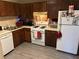 Functional kitchen featuring standard appliances and dark wood cabinets at 6473 Bedford Ln, Lithonia, GA 30058