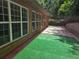 Brick home exterior with an enclosed yard with artificial turf and privacy fence at 2110 Retreat Haven Ln, Dacula, GA 30019