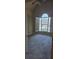 Carpeted bedroom with arched window and shutter at 2110 Retreat Haven Ln, Dacula, GA 30019