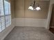 Dining room with a chandelier, wainscoting and neutral carpet at 2110 Retreat Haven Ln, Dacula, GA 30019