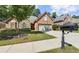 Charming brick home features a manicured lawn, stone accents and a two-car garage at 2110 Retreat Haven Ln, Dacula, GA 30019