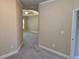 Hallway view of the bedroom, featuring neutral walls, plush carpet, and ample space at 2110 Retreat Haven Ln, Dacula, GA 30019