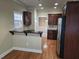 Open kitchen with dark wood cabinets, granite counters, and hardwood floors at 2110 Retreat Haven Ln, Dacula, GA 30019
