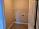 Convenient laundry room with tile flooring and shelf at 2110 Retreat Haven Ln, Dacula, GA 30019