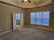 Spacious main bedroom with tray ceilings, plush carpet, and attached bathroom at 2110 Retreat Haven Ln, Dacula, GA 30019