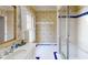 Charming bathroom featuring blue-patterned wallpaper, white tiled floors, and a glass-enclosed shower at 3131 Nw Slaton Nw Dr # 24, Atlanta, GA 30305